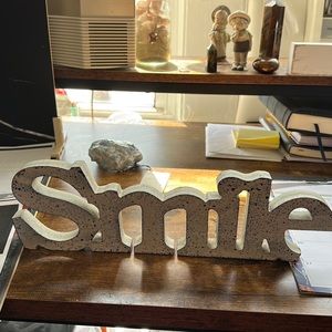 “Smile” sign